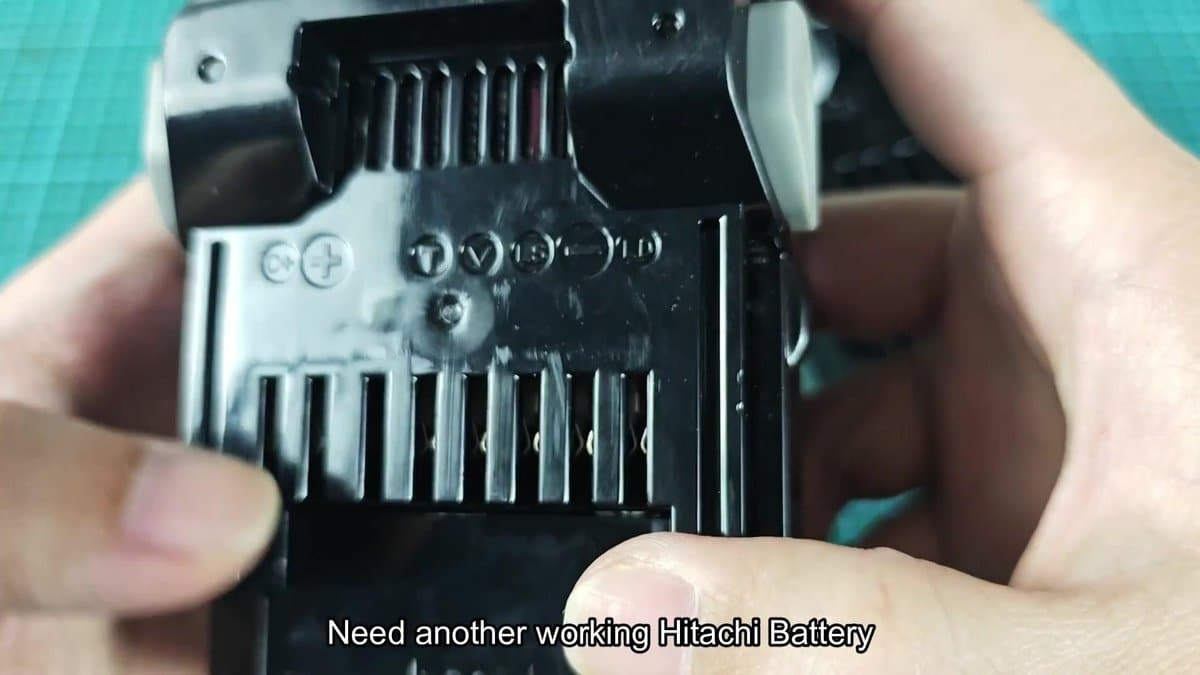 Hitachi battery terminal with embossed symbols