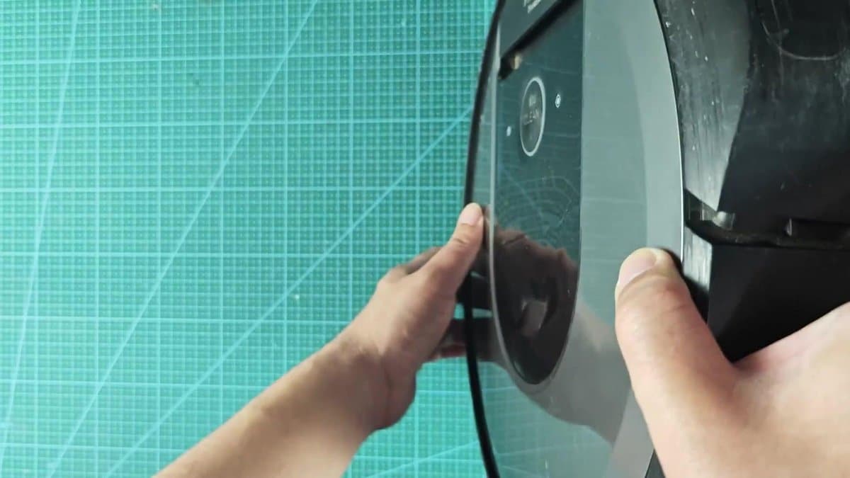 iRobot vacuum being assembled on cutting mat