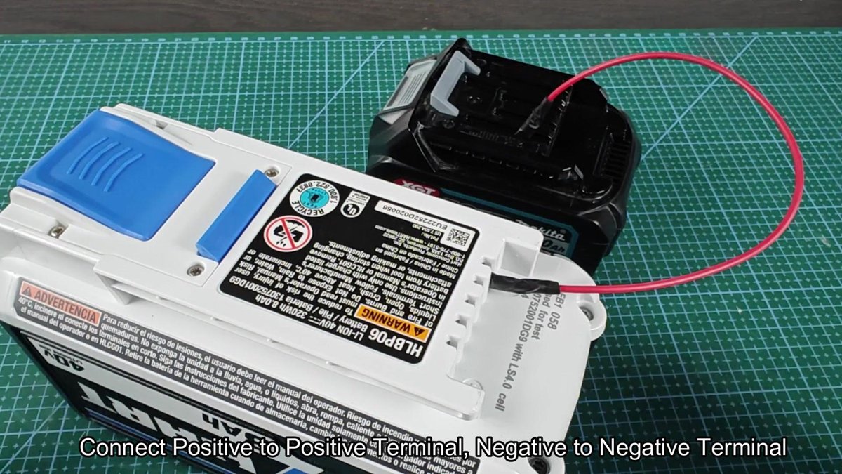 Makita 40V battery wired to device on mat