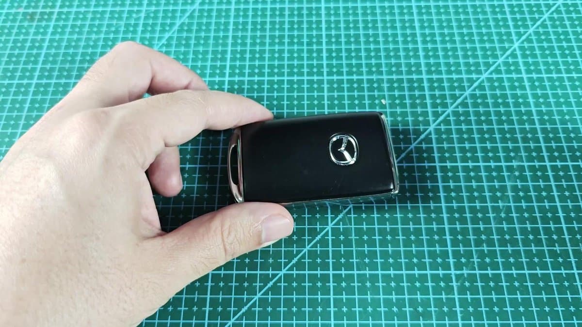 Mazda car key fob on green cutting mat