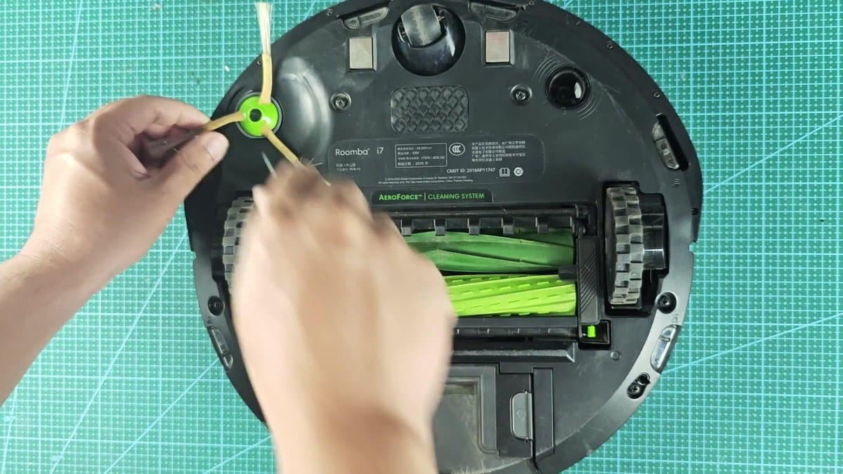 Roomba i7 with cleaning brush being removed