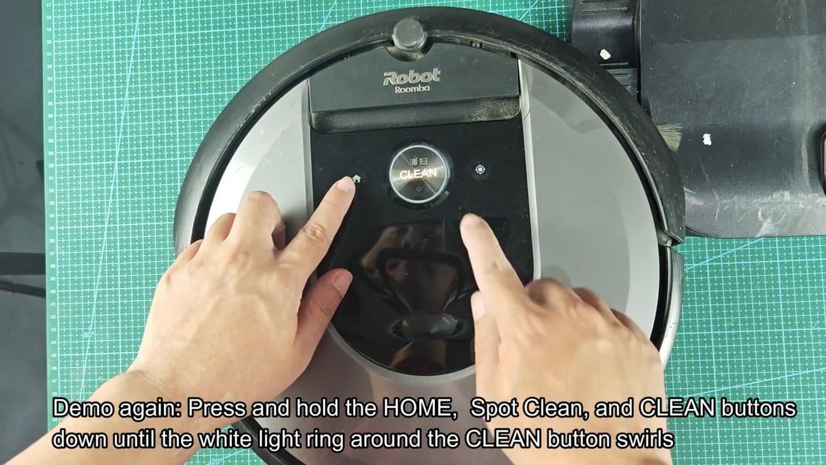 Roomba robot vacuum buttons being pressed