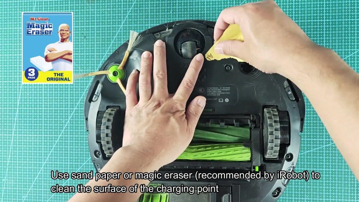 Roomba with cleaning brush and sandpaper nearby