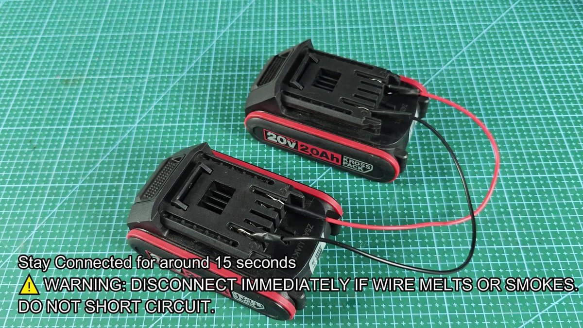 Two Kross Packs 20V batteries on grid mat