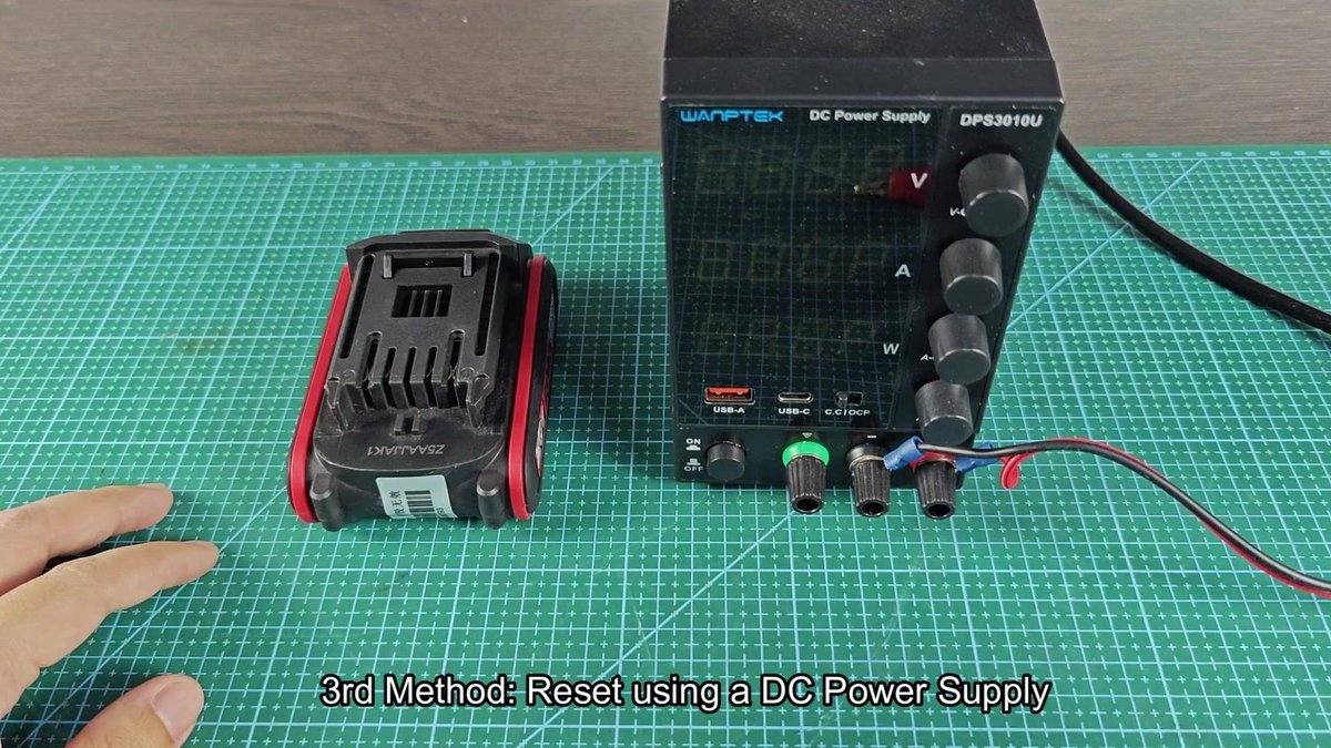 Wamptek DC power supply next to drill battery