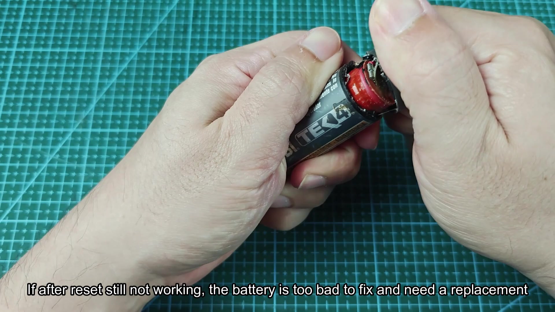 Battery casing opened revealing red internal cell