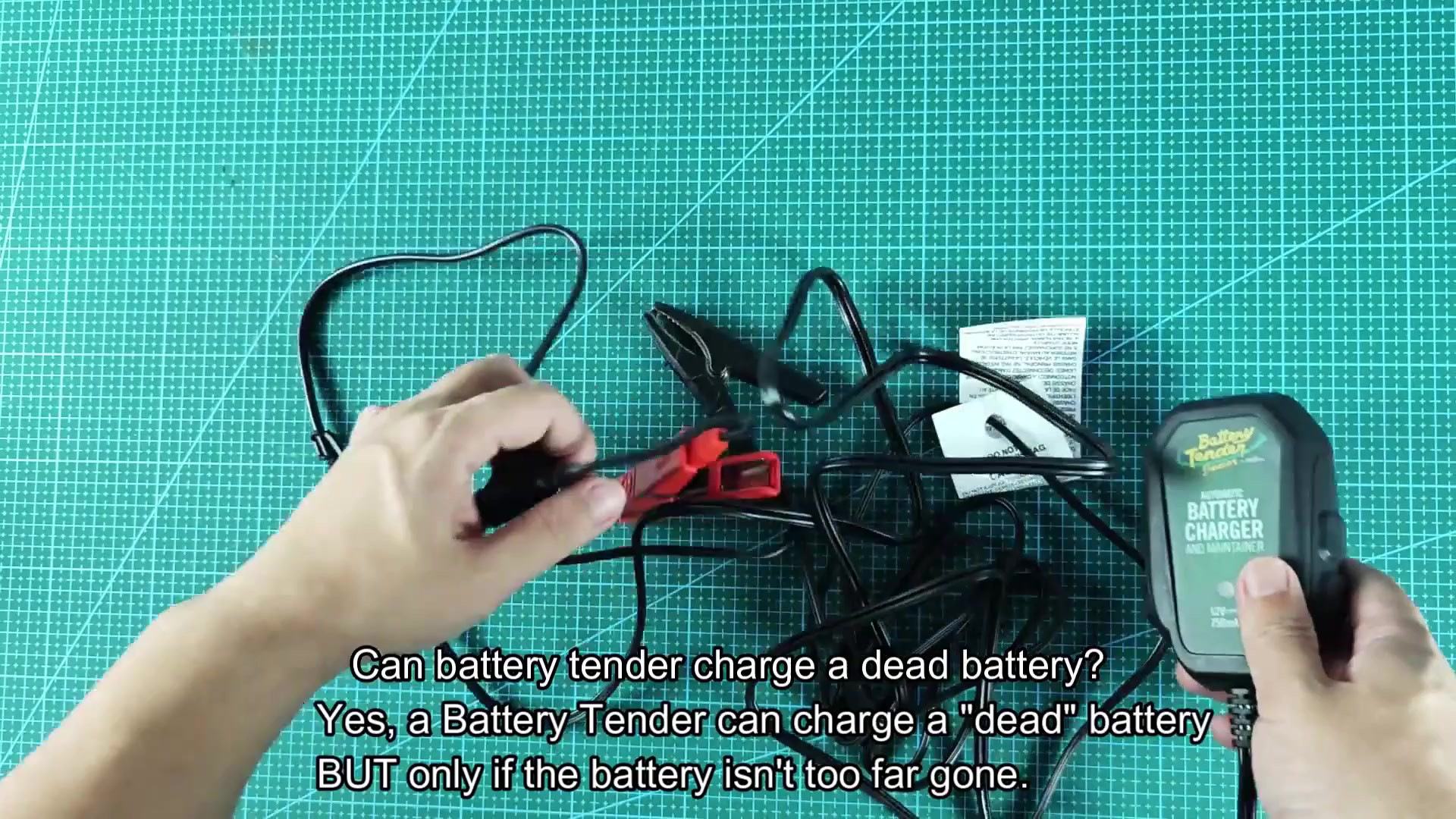 Battery Tender Junior with clamps on cutting mat Battery Tender Junior with clamps on cutting mat