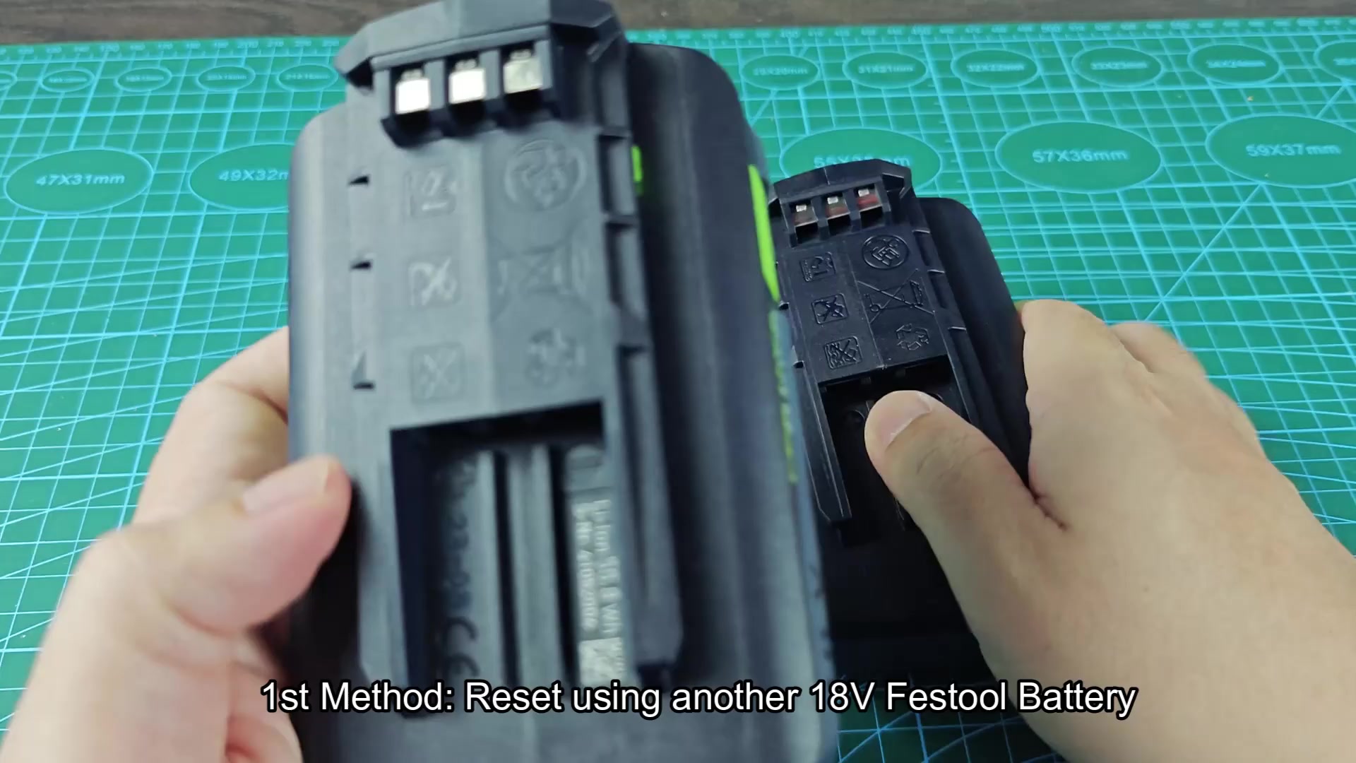 Battery terminal bay showing positive and negative symbols Battery terminal bay showing positive and negative symbols