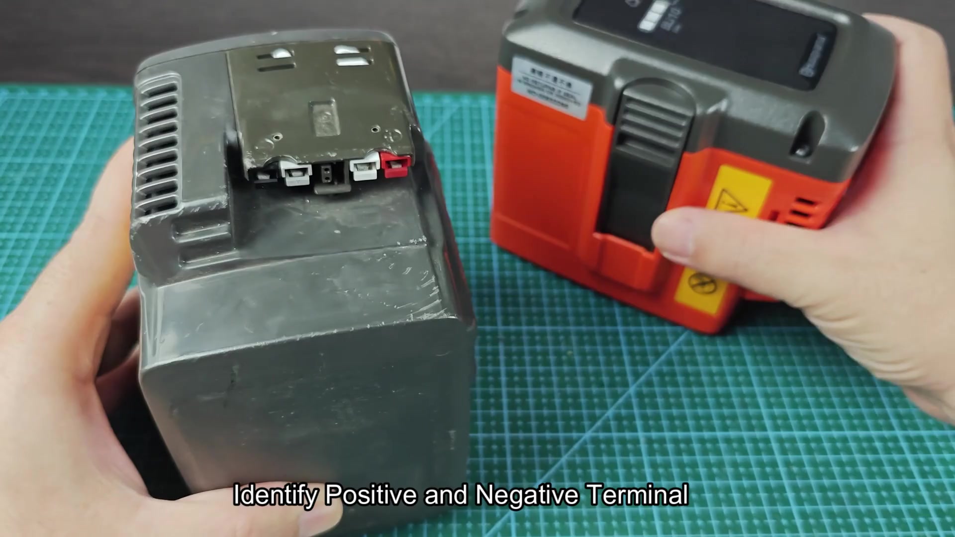 Black and orange battery packs on cutting mat Black and orange battery packs on cutting mat