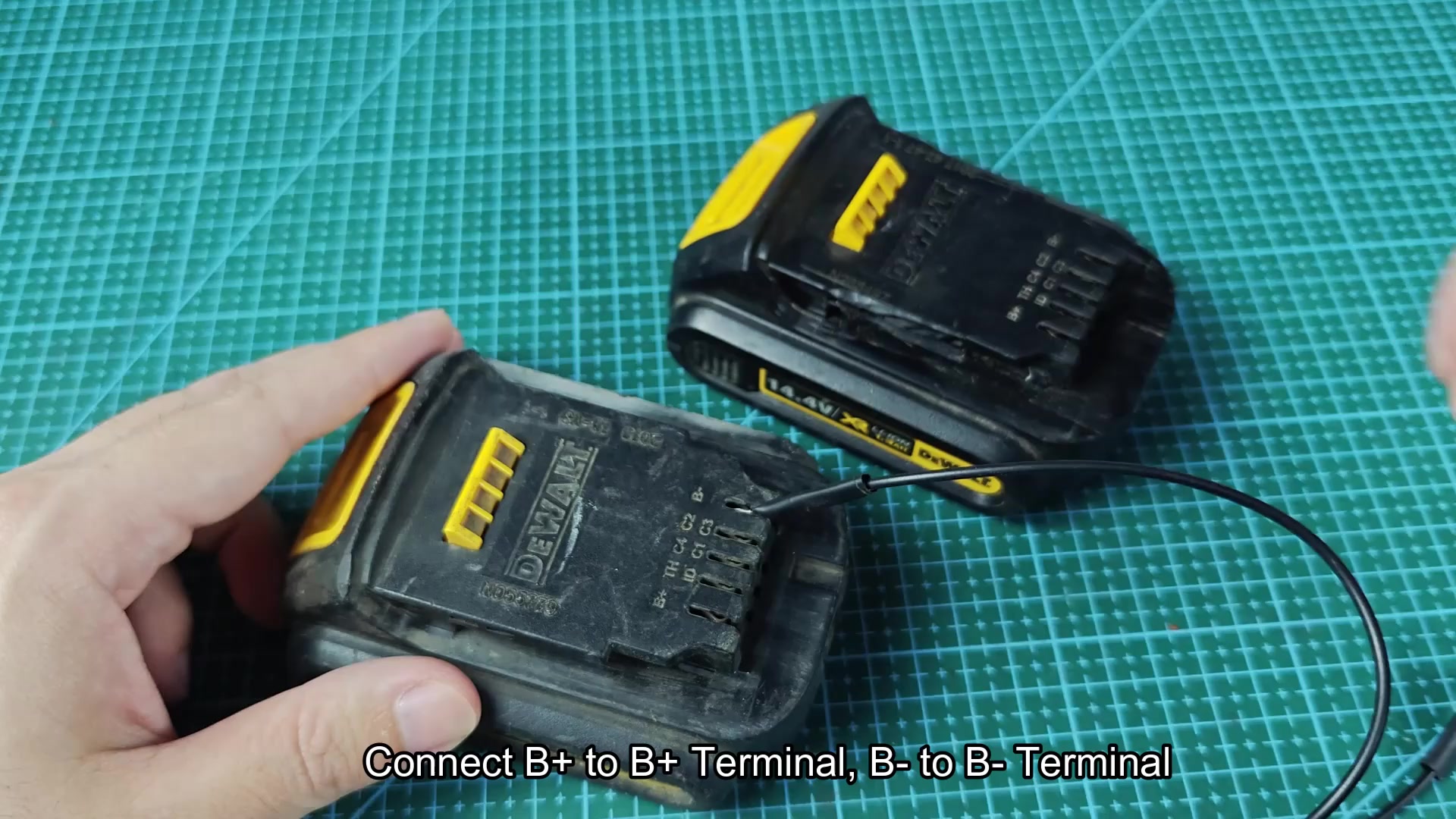 Black wire positioned at DEWALT battery terminals Black wire positioned at DEWALT battery terminals