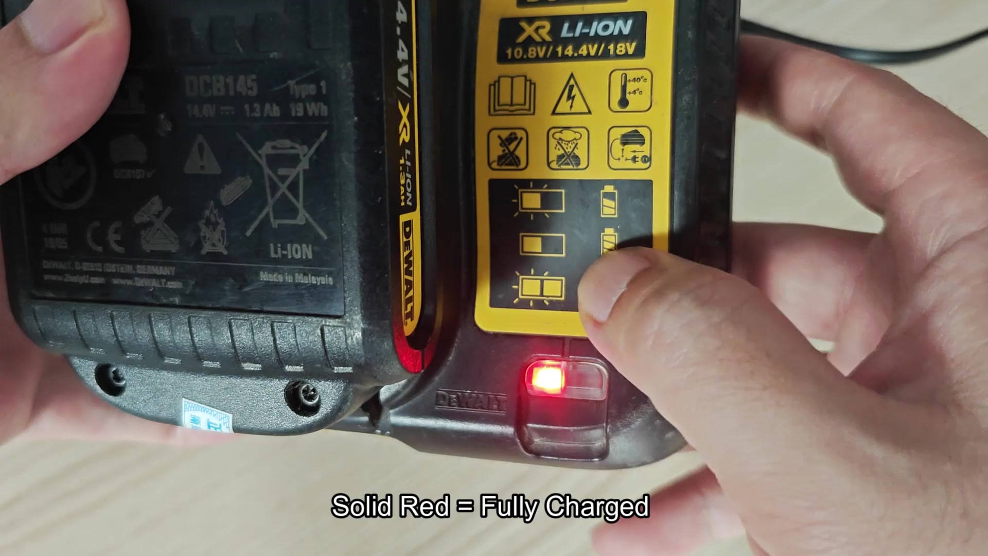 DCB107 solid red LED means fully charged
