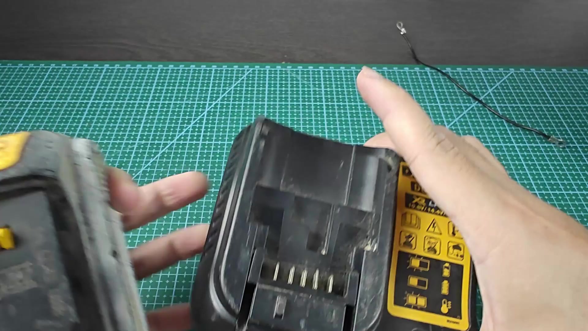 DEWALT battery positioned over DCB107 charger DEWALT battery positioned over DCB107 charger