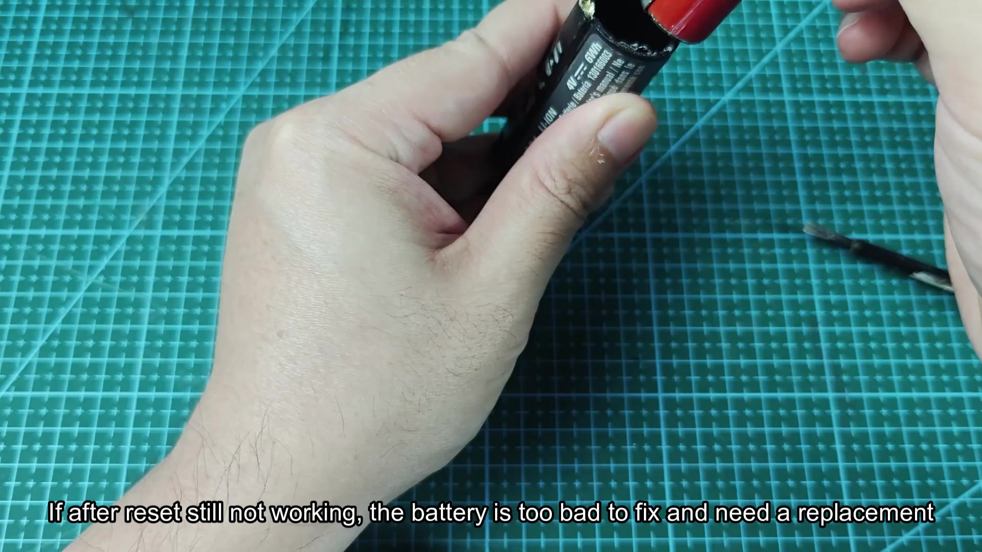 Disassembled battery showing two red cylindrical cells