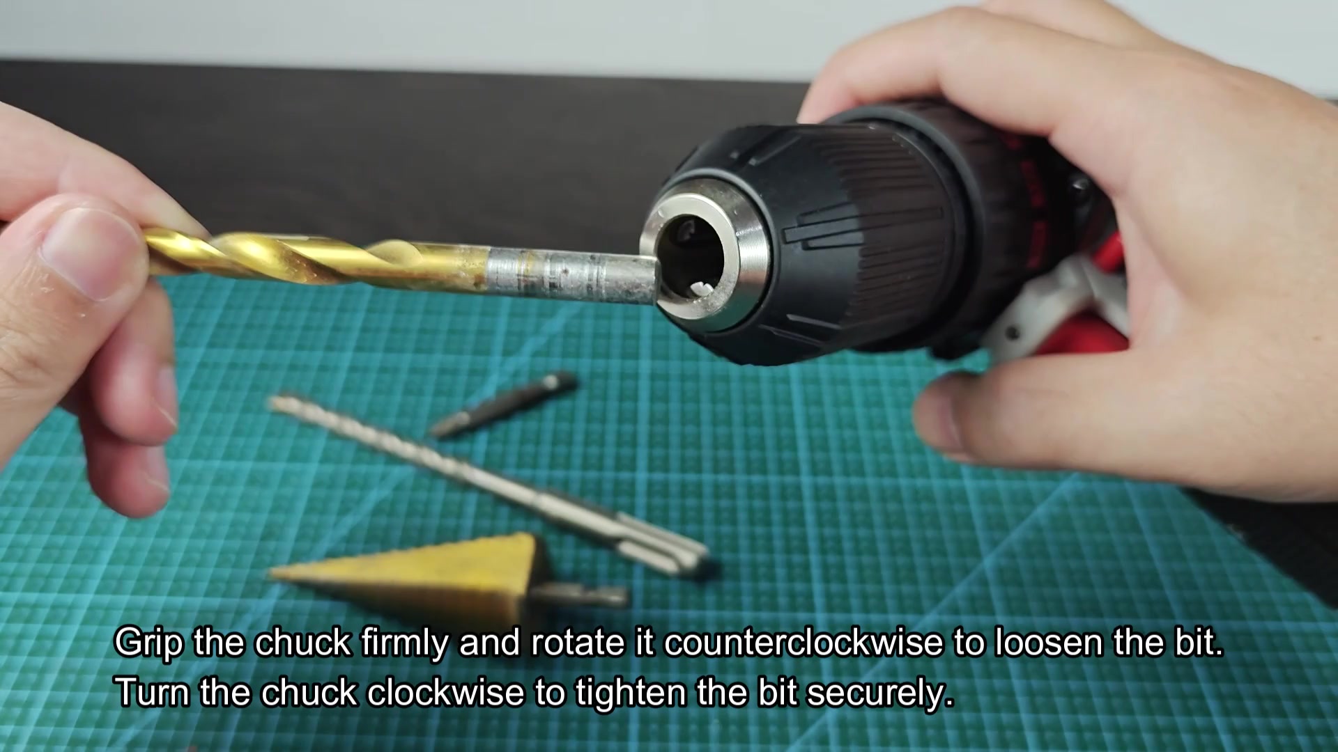 Gold drill bit inserted into drill chuck Gold drill bit inserted into drill chuck