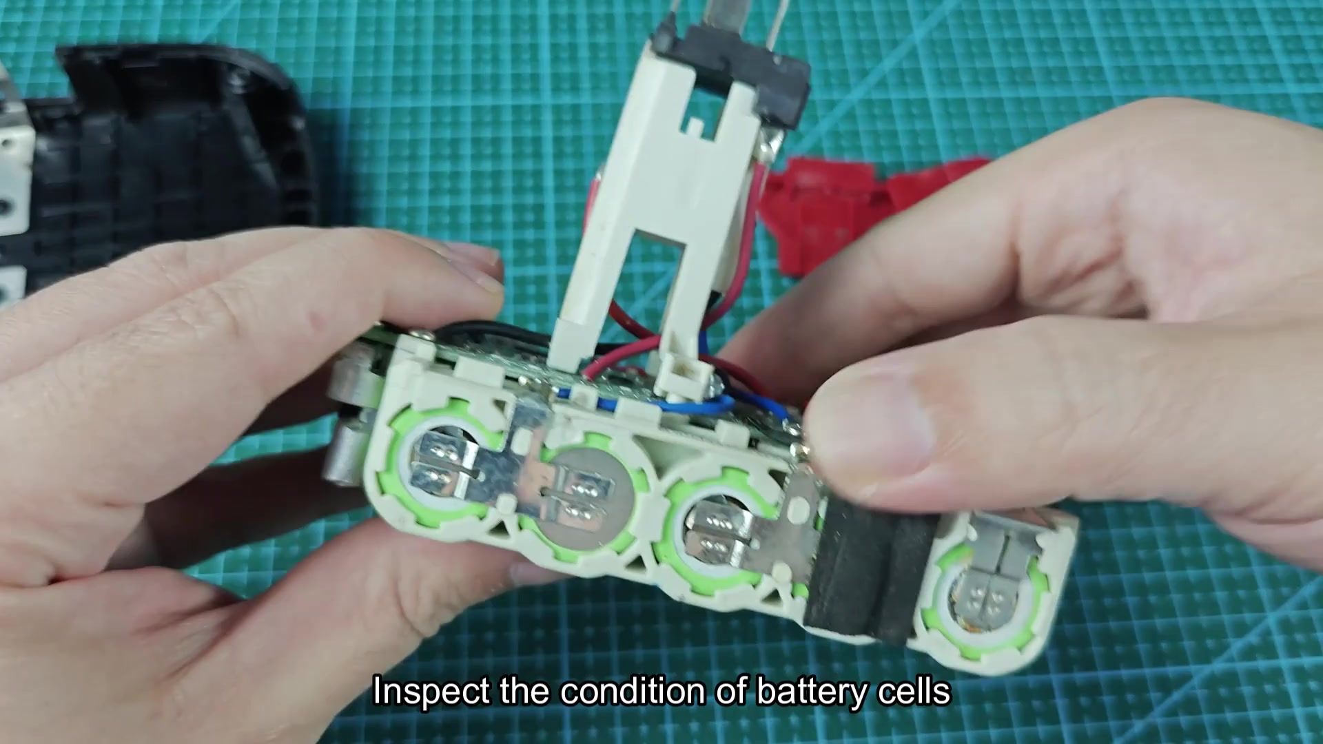 Green cylindrical battery cells with LG cell markings visible Green cylindrical battery cells with LG cell markings visible