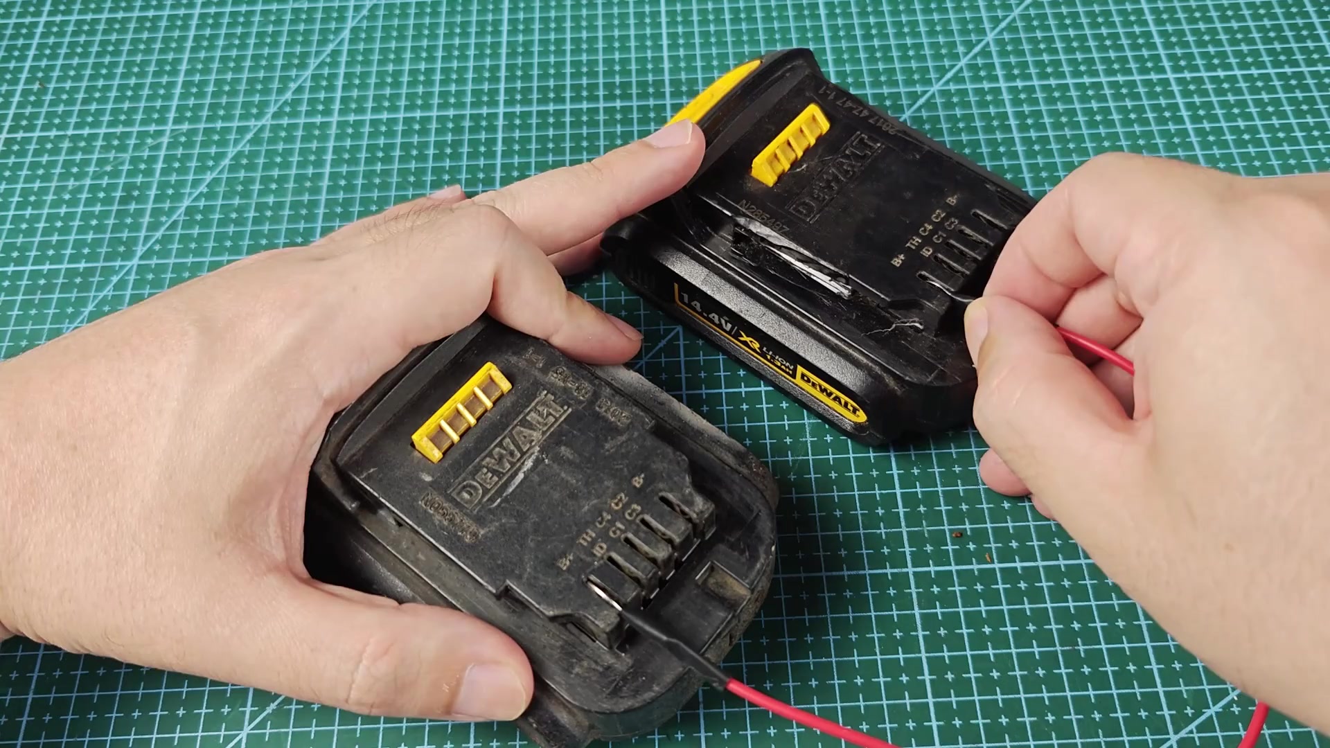 Metal probe near DEWALT battery contact area Metal probe near DEWALT battery contact area