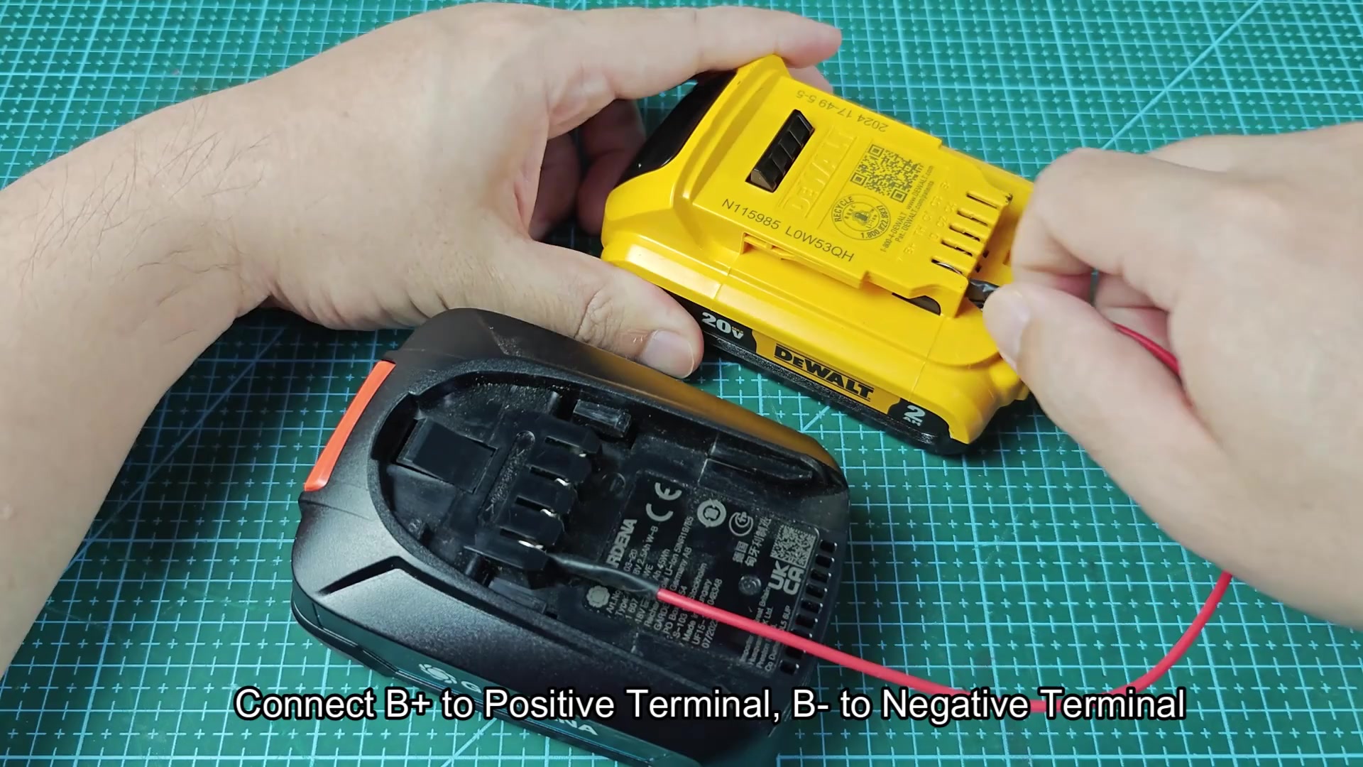 Red wire connecting DeWALT battery to Gardena terminals