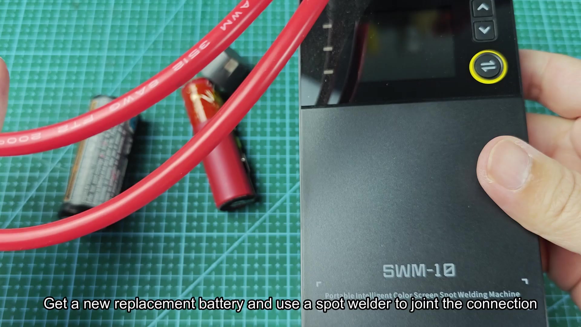 Spot welder probes beside battery and replacement cell