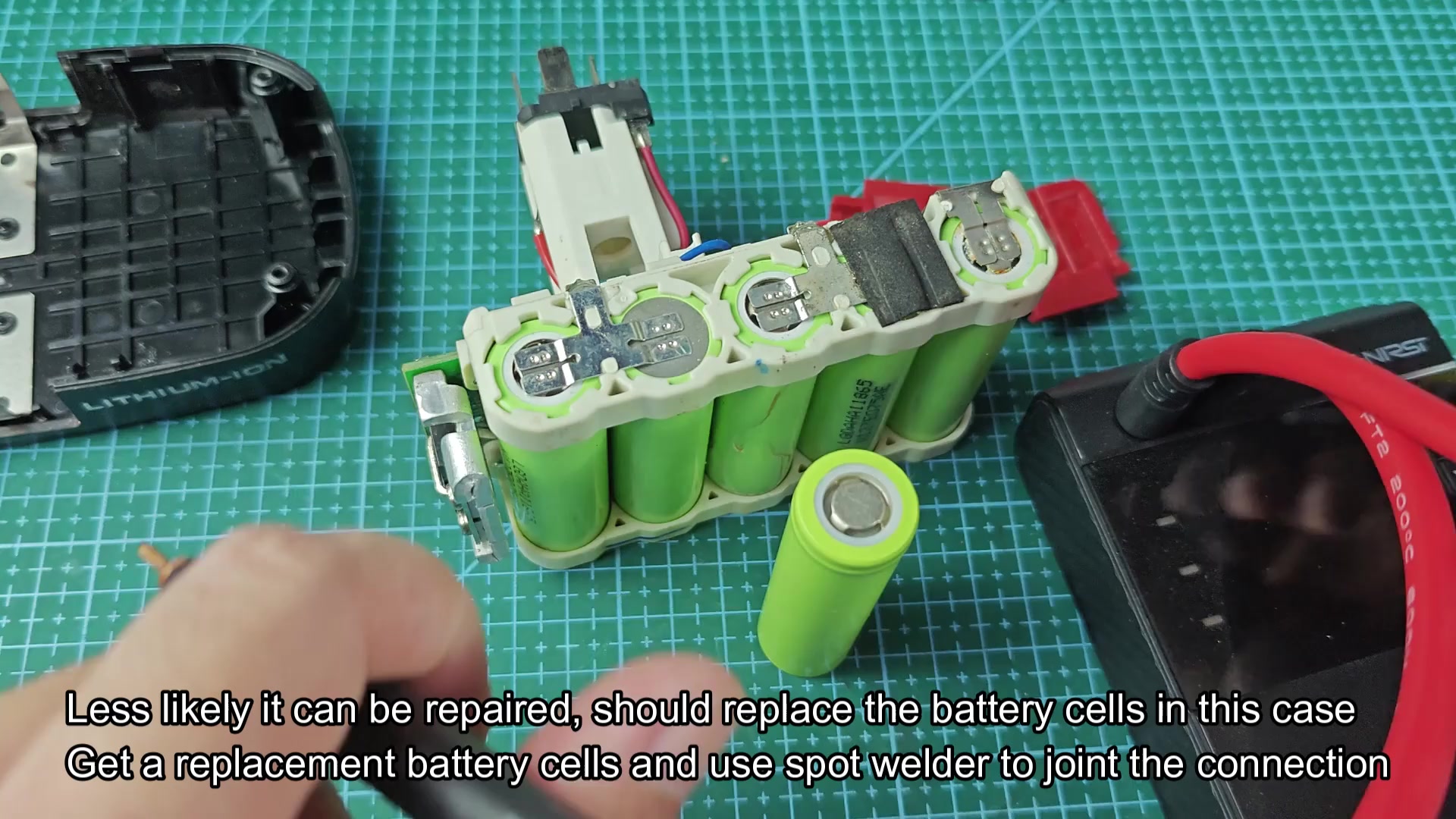 Spot welder tool being applied to battery cell metal tabs Spot welder tool being applied to battery cell metal tabs