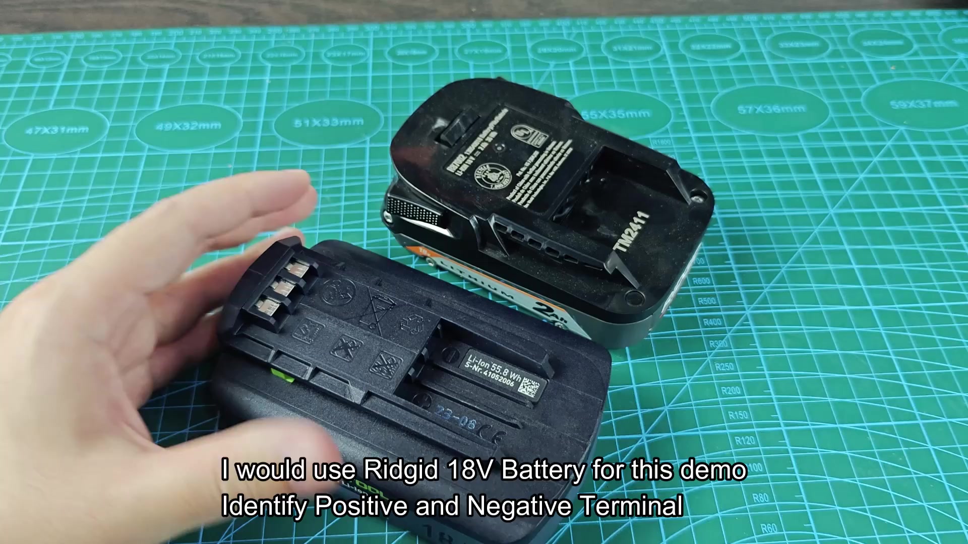 Two battery packs with terminals exposed on mat Two battery packs with terminals exposed on mat