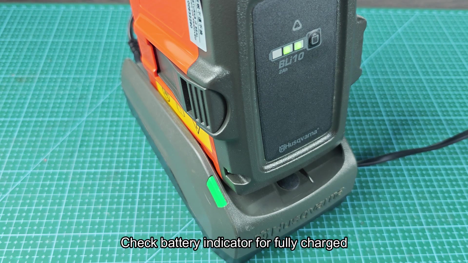 Yellow warning label on Husqvarna charger base Yellow warning label on Husqvarna charger base