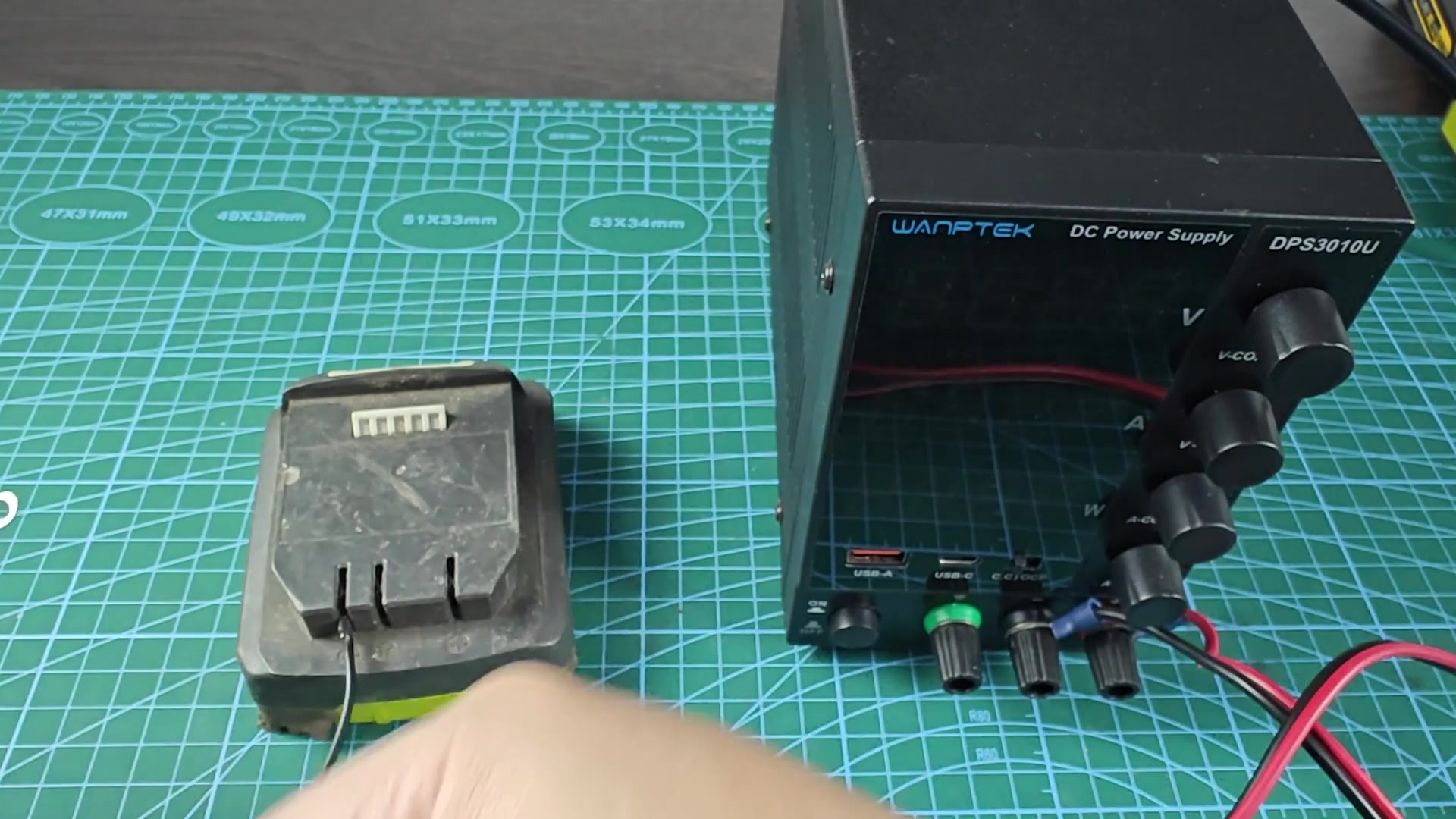 Battery pack on green cutting mat Battery pack on green cutting mat