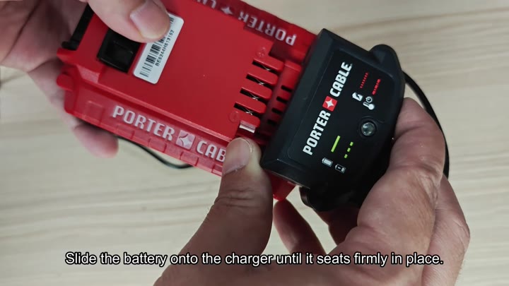 Battery sliding into black charger Battery sliding into black charger