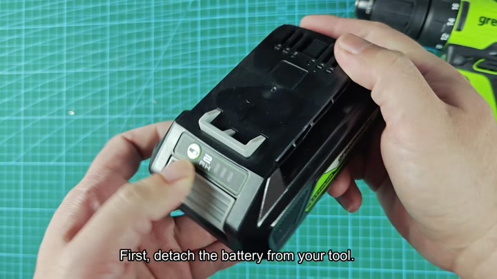 Detach battery from cordless drill