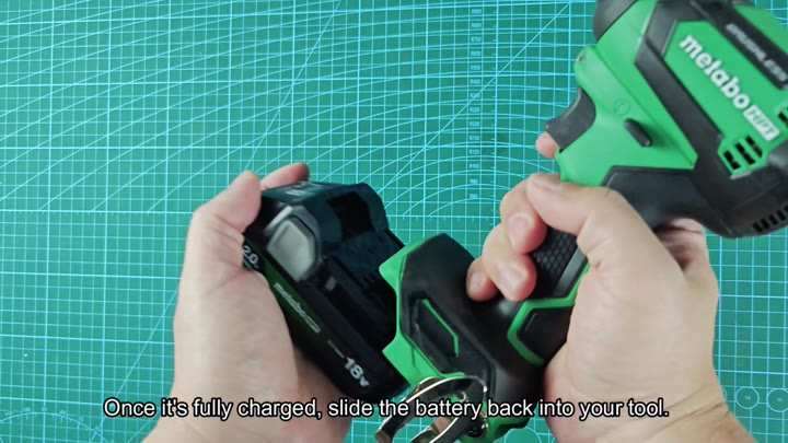 Inserting charged battery into tool