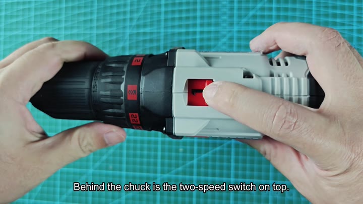 Pressing red two-speed switch on drill Pressing red two-speed switch on drill