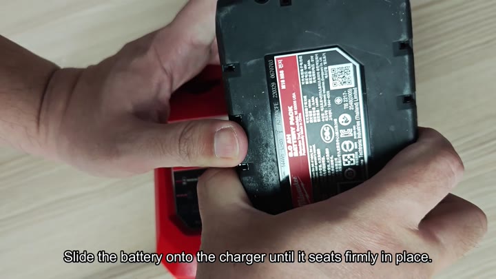 Slide battery onto charger firmly