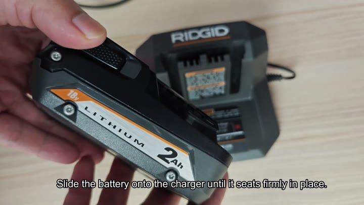 Sliding RIDGID 18V battery onto charger