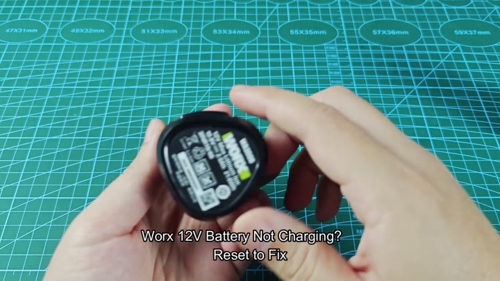 Worx 12V battery on green mat