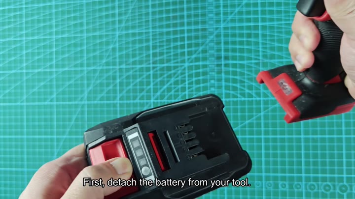 Detach battery from power tool