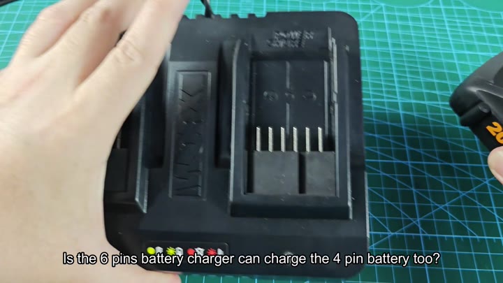 Dual-bay charger showing six metal pins Dual-bay charger showing six metal pins