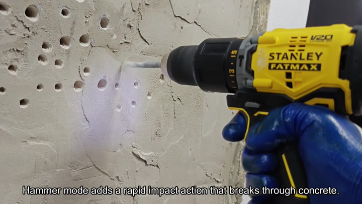 Hammer drill breaking through concrete wall Hammer drill breaking through concrete wall