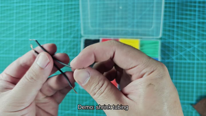 Positioning shrink tubing over wire joint Positioning shrink tubing over wire joint