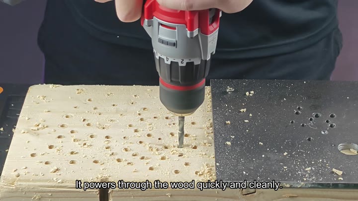 Power drill boring cleanly through wooden board Power drill boring cleanly through wooden board