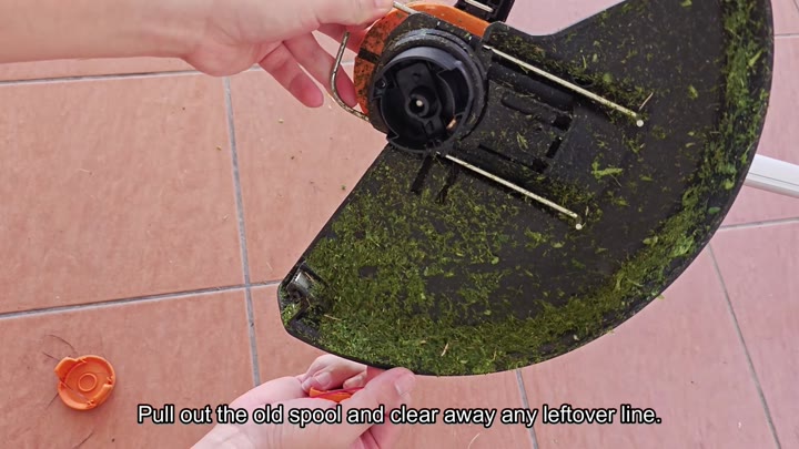 Remove old spool from trimmer head Remove old spool from trimmer head