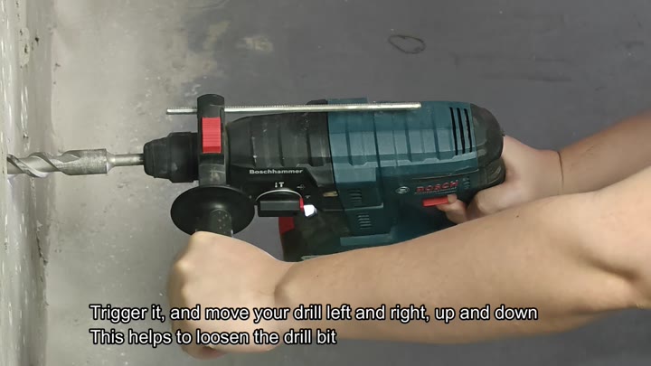 Wiggling drill to loosen stuck bit Wiggling drill to loosen stuck bit